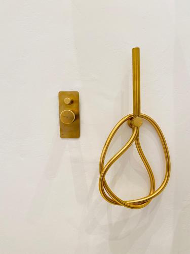 a gold object is hanging on a wall at Gerani Deluxe Houses in Astypalaia Town