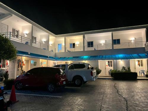 two cars parked in front of a building at night at Albergo El Pulpo, Bayahíbe in Bayahibe