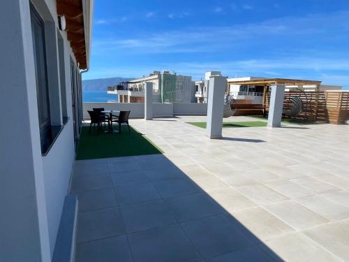 a patio with a table and chairs on a house at Luxury Rooftop Vlora in Vlorë