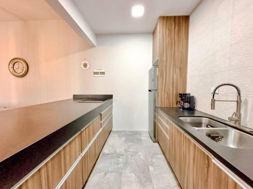 a large kitchen with a sink and a refrigerator at Casa Georgia at Kino Bay - Moderna y acogedora. in Bahía Kino