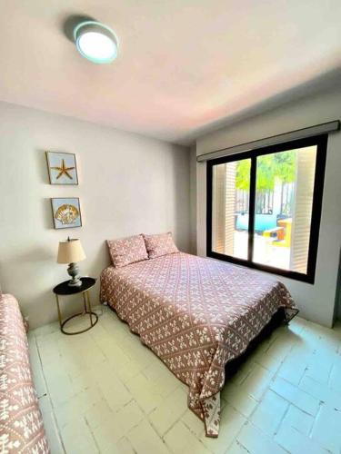 a bedroom with a bed and a large window at Casa Georgia at Kino Bay - Moderna y acogedora. in Bahía Kino