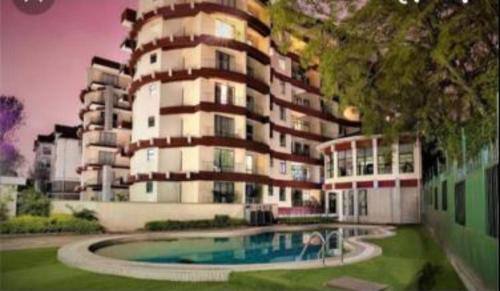 a building with a swimming pool in front of a building at Casa ozone in Nairobi