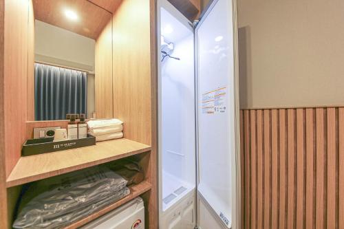 a walkin closet with a glass shower in a bathroom at H Avenue Hotel Geumho in Gwangju