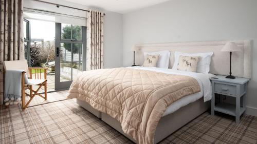 a bedroom with a large bed and a balcony at Number Nine in Lanchester