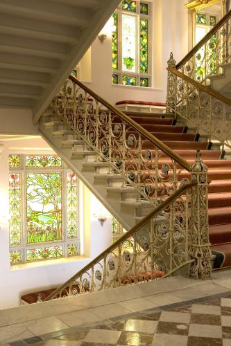 a staircase in a home with stained glass windows at Grand Hotel Lund in Lund
