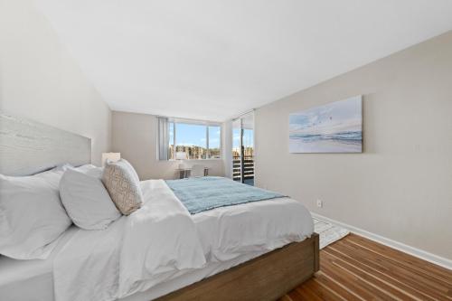 a white bedroom with a large bed and a window at Stunning Waterfront Marina Apt Breathtaking Views in Los Angeles