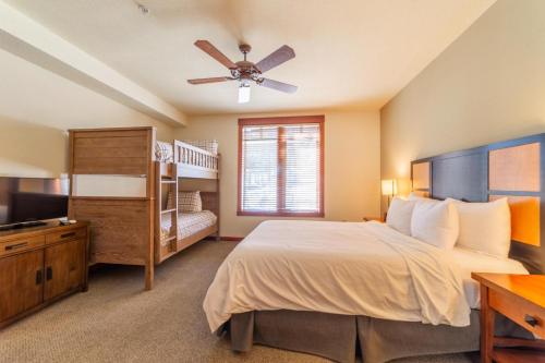 a bedroom with a large bed with a ceiling fan at #535- Village, Walk to Gondola, Restaurants, and Shops in Mammoth Lakes