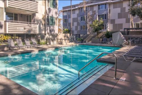a large swimming pool with chairs and a building at Stunning Waterfront Marina Apt Breathtaking Views in Los Angeles