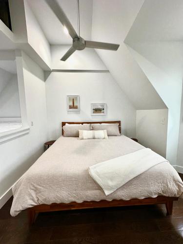 a bedroom with a bed with a ceiling fan at CWE Luxury La Maison Modern in Tower Grove