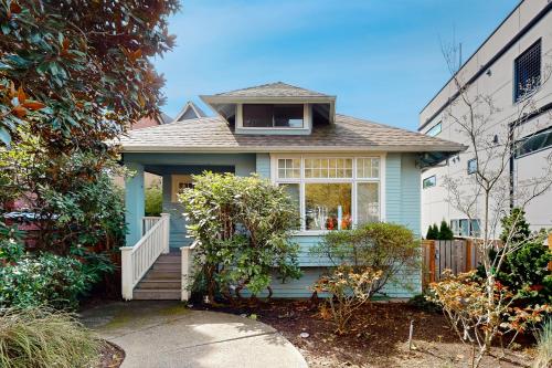 a small blue house with a porch and a window at Greenlake Hidden Oasis in Seattle
