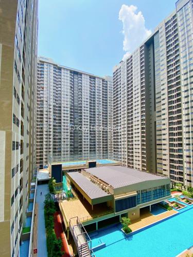 a large building with a swimming pool in front of it at Youth City 2 Bedroom Pool View by DKAY in Nilai in Nilai