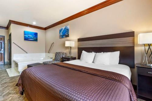 a hotel room with a bed and a bath tub at Best Western Fort Worth Inn & Suites in Fort Worth