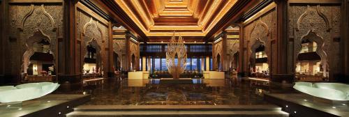 a large lobby with a chandelier in a building at The Apurva Kempinski Bali in Nusa Dua