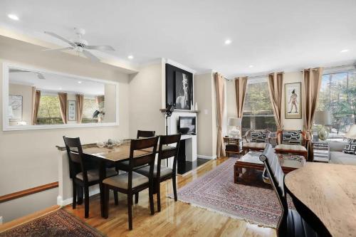 a dining room and living room with a table and chairs at DC's Best Address -10min to White HSE - 500 mbps in Washington, D.C.