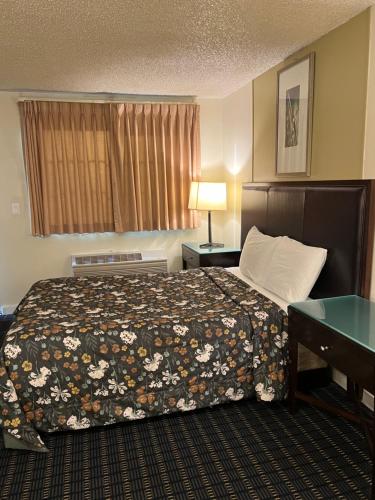 a hotel room with a bed and a window at Columbus Motor Inn in Seattle