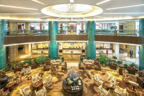 a large lobby with chairs and tables in a building at Kempinski Hotel Chengdu-City Center in Chengdu