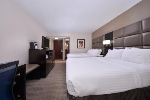 a hotel room with two beds and a television at Holiday Inn Express Burlington, an IHG Hotel in Burlington