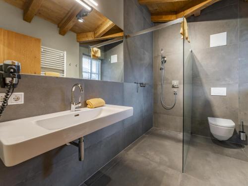 a bathroom with a sink and a shower at Schneeflocke Leogang in Leogang