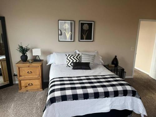 a bedroom with a bed with a black and white blanket at Cozy Springs in Mesquite