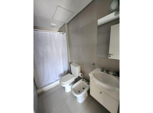 a bathroom with a toilet and a sink at Alsina 125 in Junín