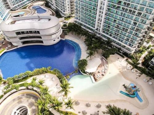 an aerial view of a resort with a pool at Azure skyview 1BR netflix karaoke ps3 Airport in Manila