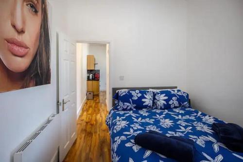 a bedroom with a bed and a picture of a woman at No4 Garlands Apartment in Saint Annes on the Sea