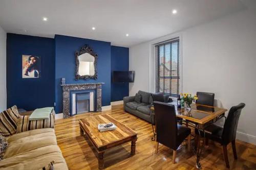 a living room with a couch and a table at No4 Garlands Apartment in Saint Annes on the Sea