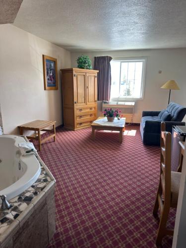 a living room with a couch and a table at Columbine Inn and Suites in Leadville