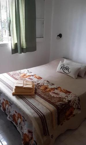 a bedroom with a bed with a pillow on it at Ruka Leufu in Santa Rosa de Calamuchita