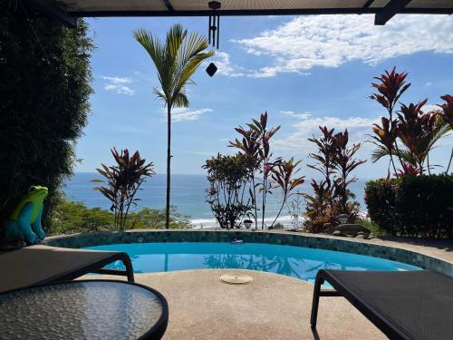 a swimming pool with a view of the ocean at Villa Del Mar 1 Spectacular ocean view! in Dominical