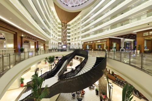 a large shopping mall with a spiral staircase in it at Sueno Hotels Deluxe Belek in Belek