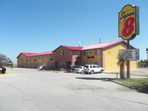 a sign for a super motel in a parking lot at Super 8 by Wyndham Moriarty in Moriarty