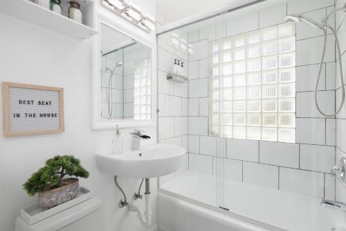 a white bathroom with a sink and a shower at 3 Bedroom with Ocean View Jacuzzi and Parking in San Diego