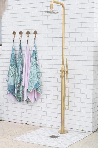 a group of umbrellas hanging on a wall at The Villa's Mooloolaba in Mooloolaba