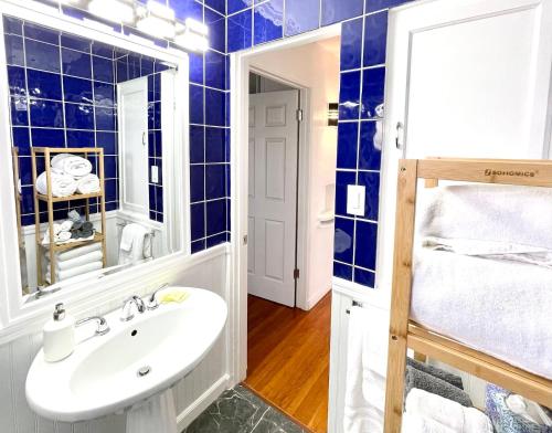 a bathroom with blue tiled walls and a sink at 2 Bedroom - Ocean View Hot Tub Parking - 8 Guest in San Diego