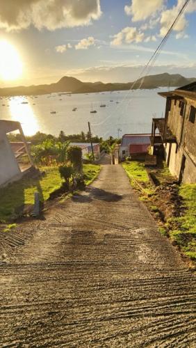 a dirt road with a view of a body of water at F2 familial - Vue imprenable sur la baie du Marin in Le Marin