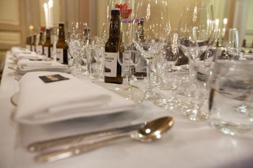 a table topped with glasses and bottles of wine at Grand Hotel Lund in Lund