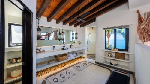 a bathroom with a large mirror and a large rug at NEW - Amapas Luxury 5-Bedroom Villa in Puerto Vallarta