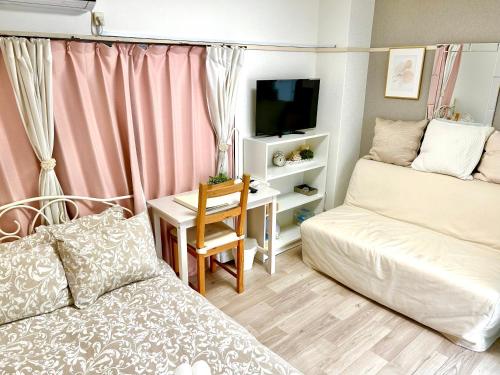 a small living room with a couch and a desk at COCO Nakameguro302 in Tokyo