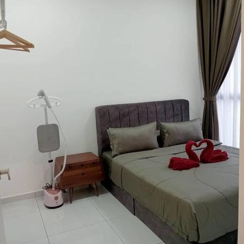 a bedroom with a bed with two red hearts on it at Cozy Sky Trees 4 Guests, Balcony, Netflix and Big TV A08 in Johor Bahru