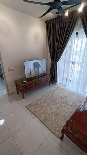 a living room with a flat screen tv on a table at Cozy Sky Trees 4 Guests, Balcony, Netflix and Big TV A08 in Johor Bahru