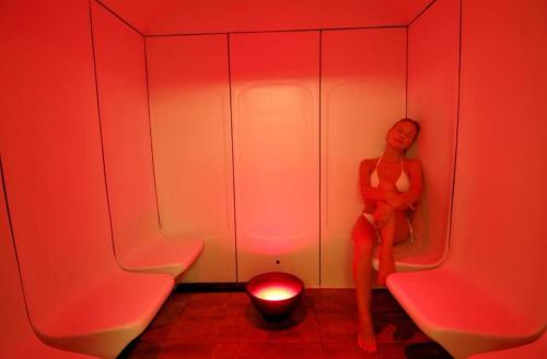 a woman sitting in a room with a red light at Ambassador Hotel & Spa- All Inclusive in Kemer