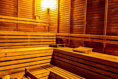 a sauna with wooden benches and a light in it at Ambassador Hotel & Spa- All Inclusive in Kemer