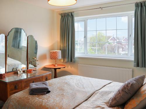 a bedroom with a bed and a large mirror at The Moorings in Rhyl