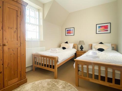 a bedroom with two beds and a window at The Old Court House in Silloth