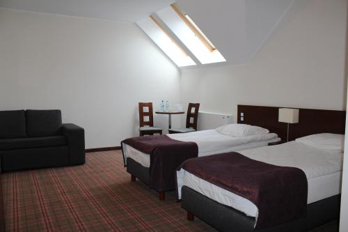 Кровать или кровати в номере Hotel Marusza