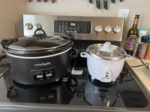 a slow cooker and a pot on a stove at The Badger House ~ Newly Remodeled Home ~ Rib Mountain in Wausau