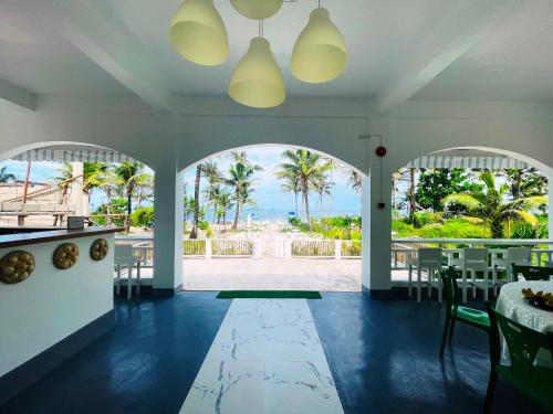 a dining room with a view of the ocean at Villa Darroca Palawan in Araceli