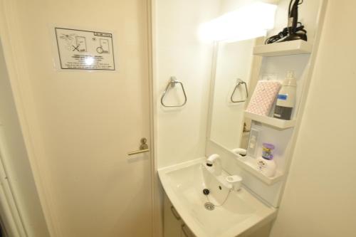 a bathroom with a sink and a mirror at Enzo iogi in Tokyo