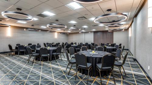 a conference room with tables and chairs in it at Holiday Inn Dallas Market Ctr Love Field by IHG in Dallas